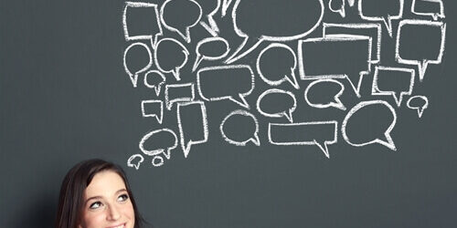 women in front of chalkboard with speech bubbles building personal brand