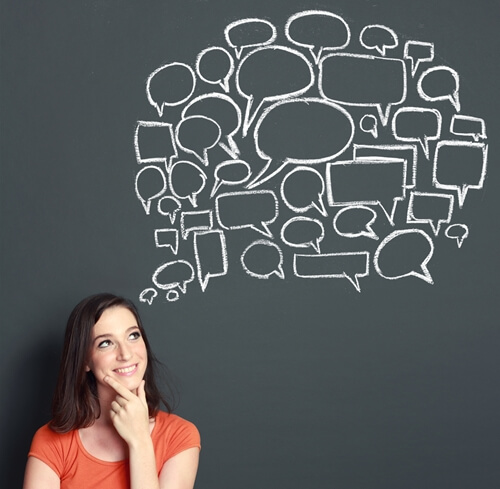 women in front of chalkboard with speech bubbles building personal brand
