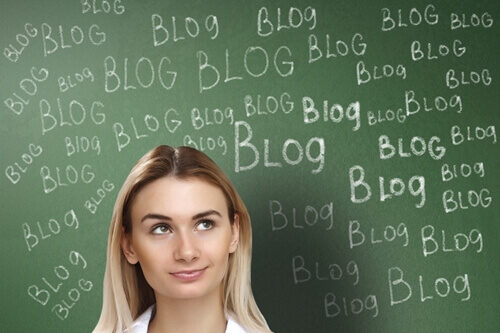 woman standing in front of chalkboard with blog written