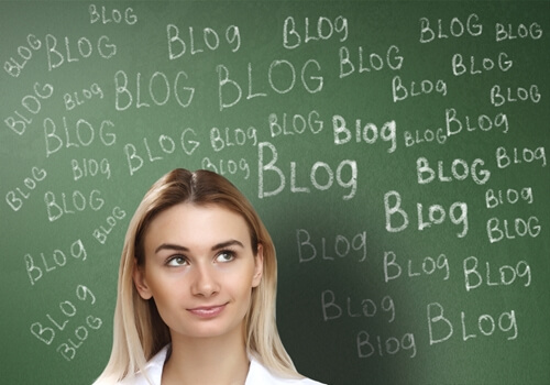 woman standing in front of chalkboard with blog written