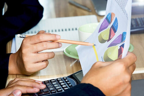 People looking at graphs on paper at a desk