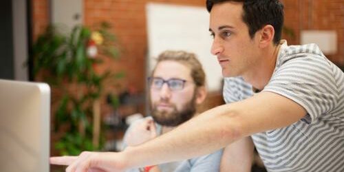 two coworkers looking at a computer