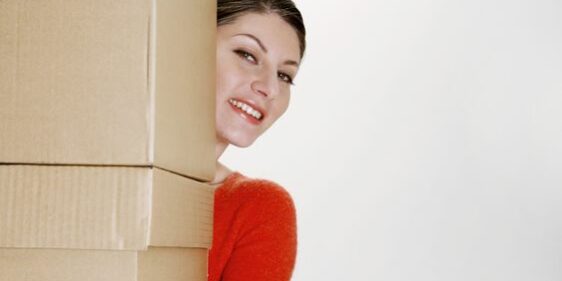 Woman carrying large boxes