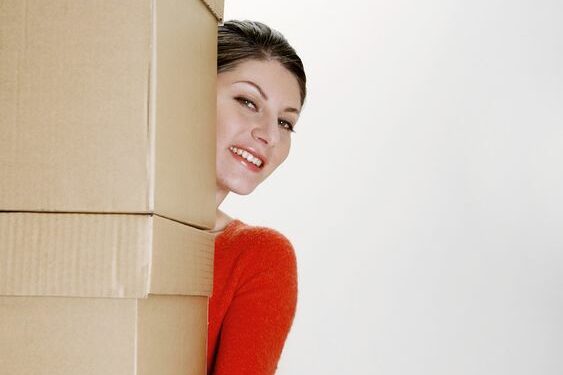 Woman carrying large boxes