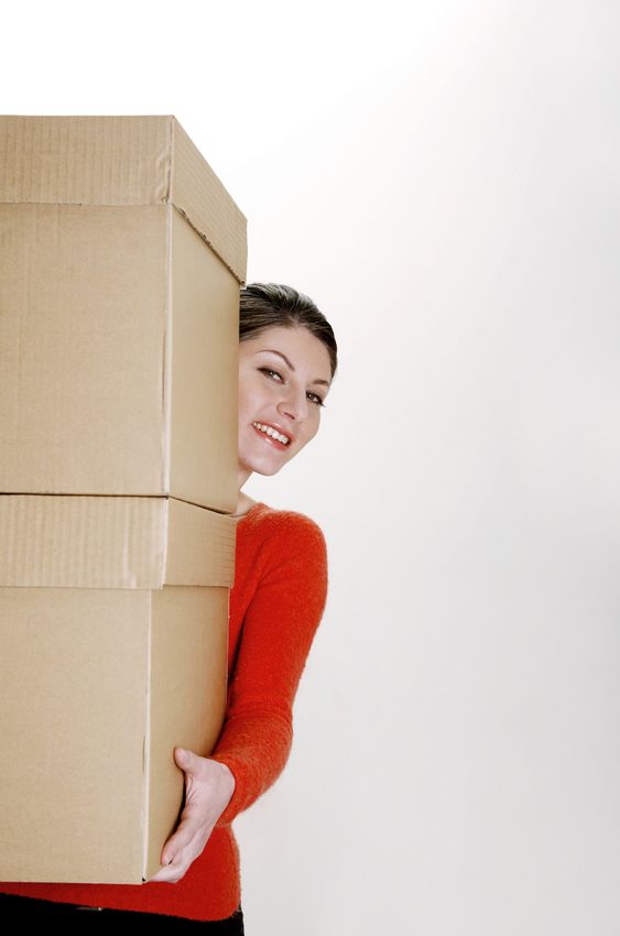 Woman carrying large boxes