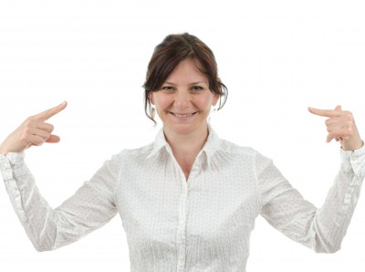 woman smiling pointing at herself