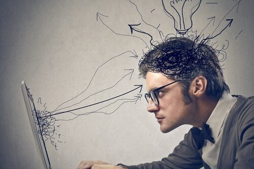 man working on a laptop with cartoon arrows and lightbulb all over his head