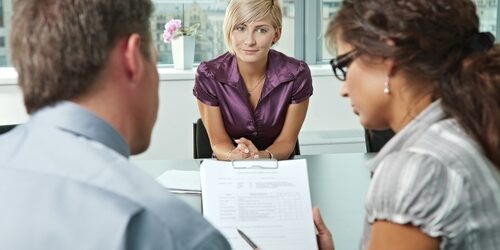 two people interviewing a woman