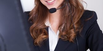 Woman working in a call center smiling a the camera