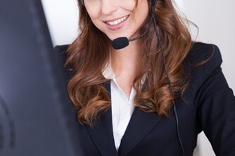 Woman working in a call center smiling a the camera