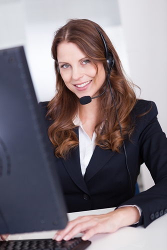 Woman working in a call center smiling a the camera