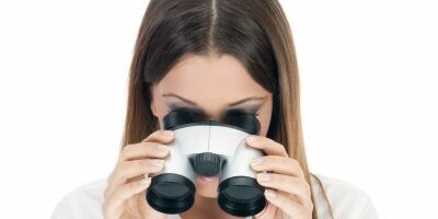 woman looking through binoculars