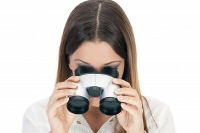 woman looking through binoculars