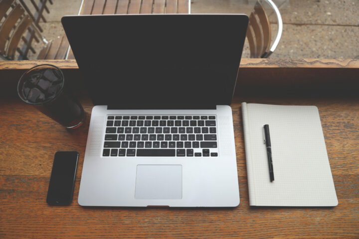 Remote Workers coffee iphone and laptop on wooden desk