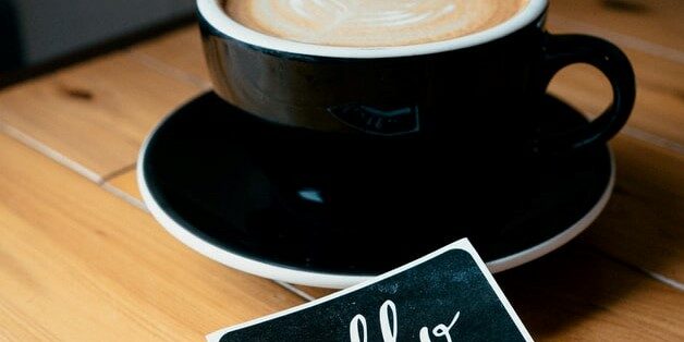 cappuccino in black mug with hello name tag remote onboarding