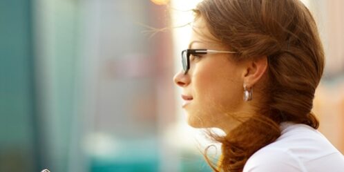 Woman on her phone looking out into the distance