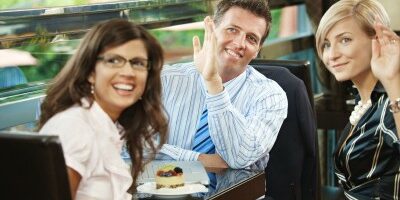 group in a restaurant waving at someone