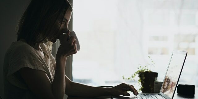 woman at computer going over hiring regulations