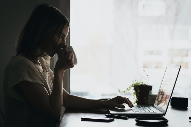 woman at computer going over hiring regulations