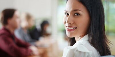 woman in a meeting smiling at the camera