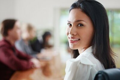 woman in a meeting smiling at the camera