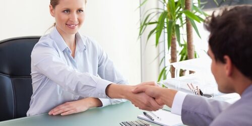 woman interviewing a man in a nice office