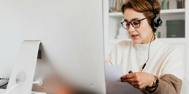 woman looking at resume while virtual interviewing