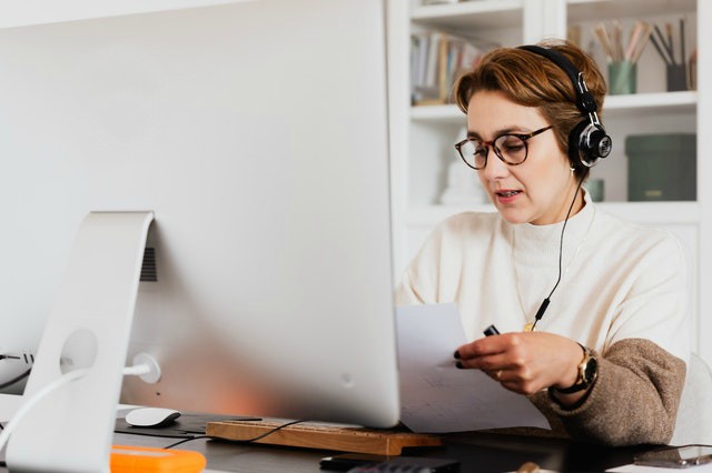 woman looking at resume while virtual interviewing