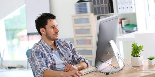 web designer at wooden desk