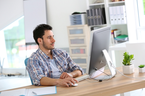 web designer at wooden desk