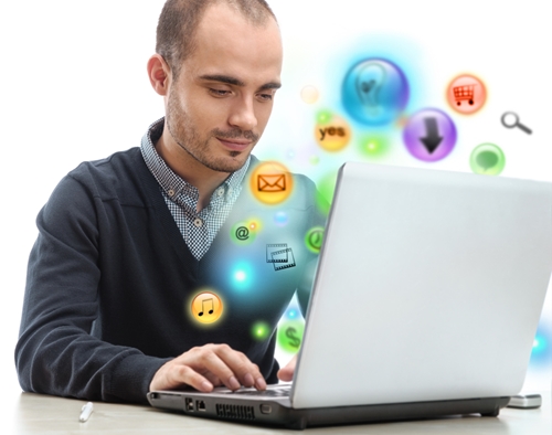 Man working on an old laptop with icon bubble floating around him