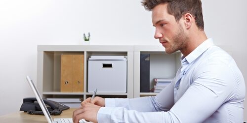 man working at his laptop at a desk