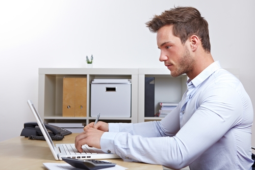 man working at his laptop at a desk