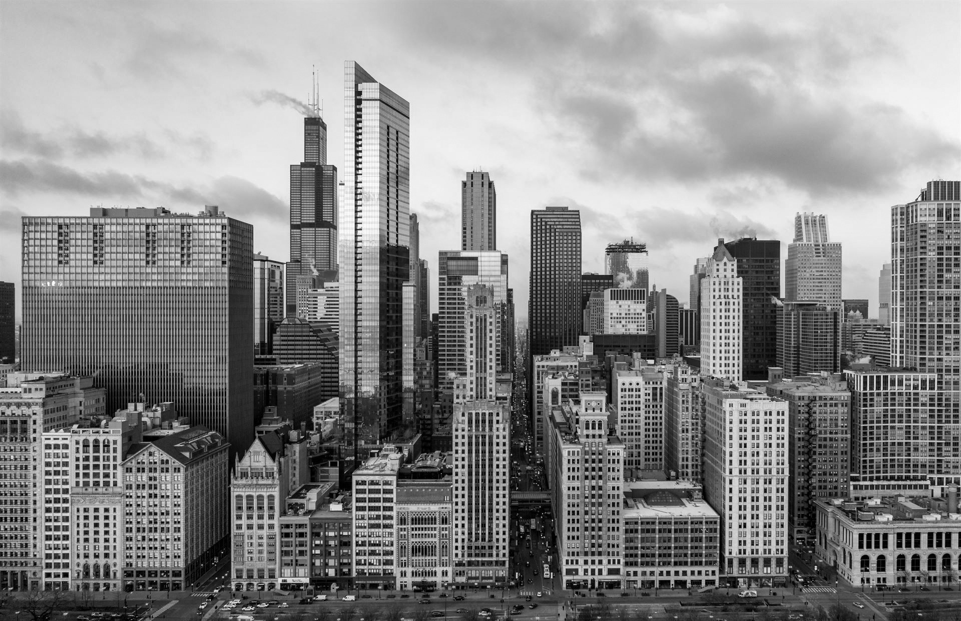 Black and white shot of a close up of the Chicago skyline from a low flying helicopter.