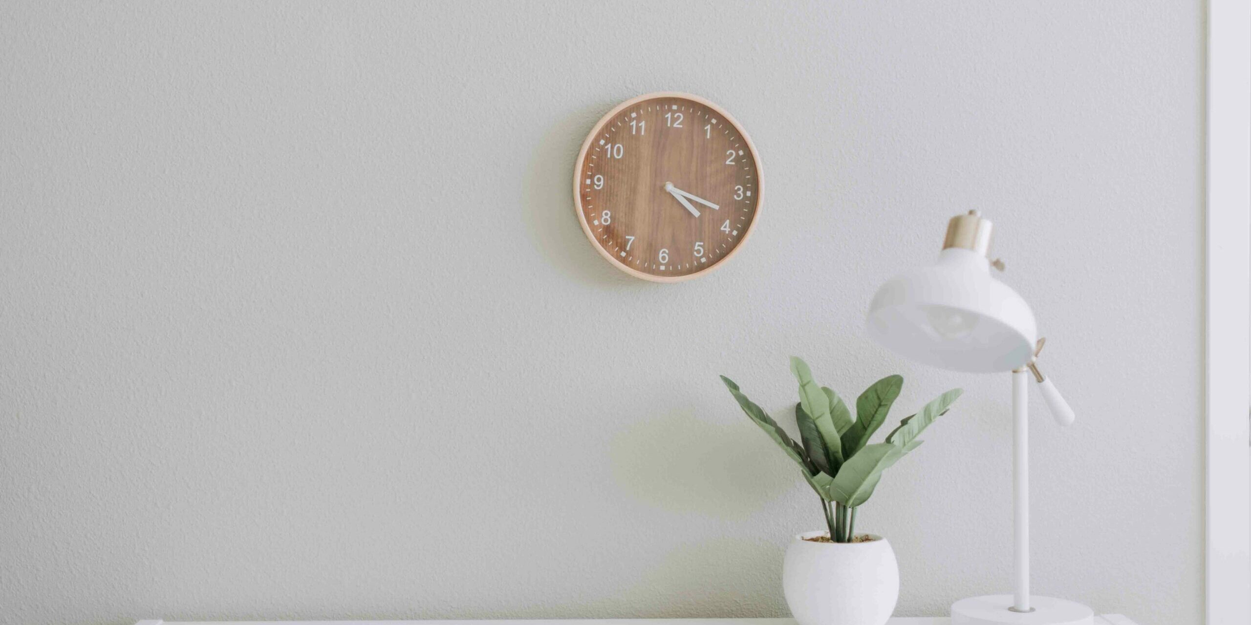 desk with clock and lamp four day work week