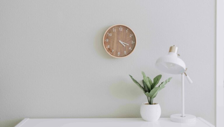 desk with clock and lamp four day work week