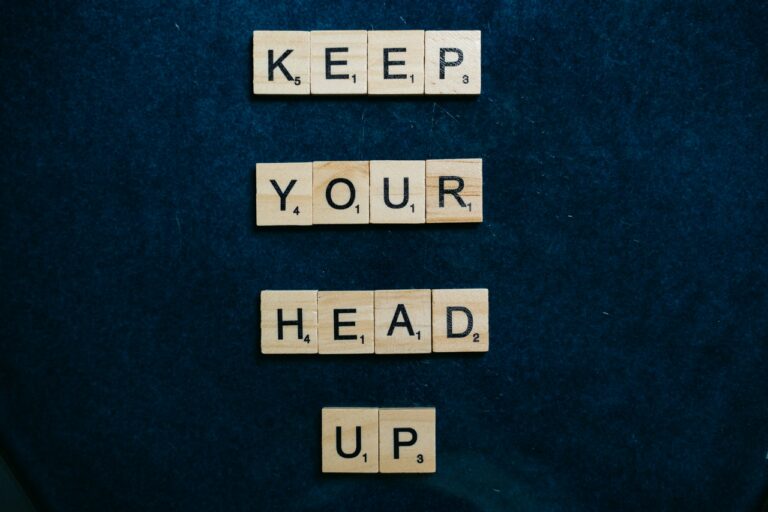 Scrabble pieces spelling out keep your head up for performance improvement plans