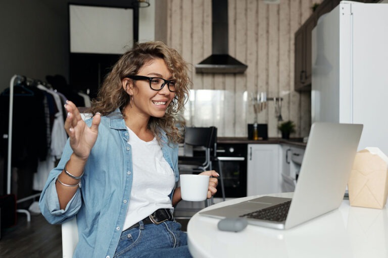 woman with coffee on computer starting new job