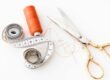 thread, scissors, and measuring tape on white background - tailor your resume to job description