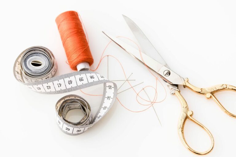 thread, scissors, and measuring tape on white background - tailor your resume to job description