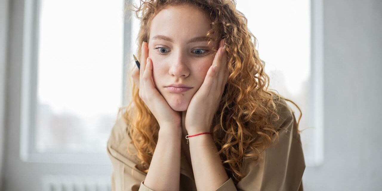 woman perplexed having to write an email asking for feedback after job rejection