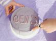 hands on light purple cake that says "gen z" - gen z in the workplace