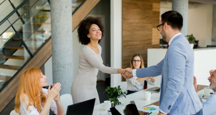 top 10 questions to ask any embedded teams vendor-1 two professionals shaking hands as if in a meeting asking the top 10 questions to ask any embedded teams vendor
