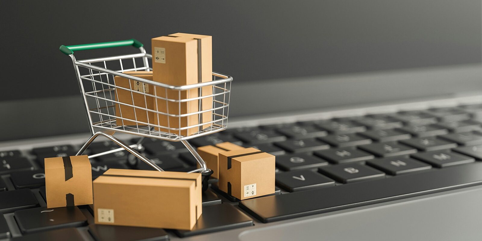 CMO in Consumer Packaged Goods - mini shopping cart with boxes on laptop