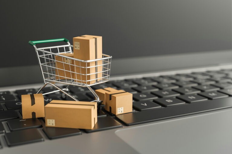 CMO in Consumer Packaged Goods - mini shopping cart with boxes on laptop
