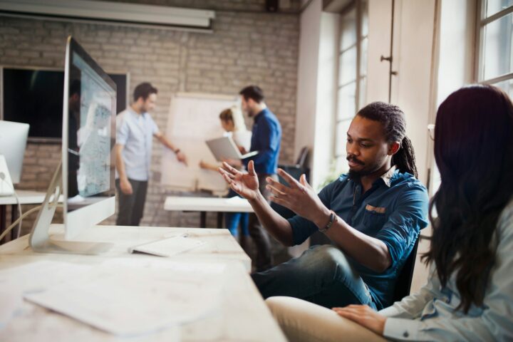 man and woman working together at desk in a digital in-demand skills-based job