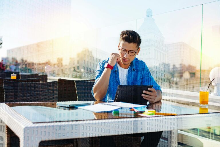 human-in-the-loop-AI professional using a tablet interacting with technology